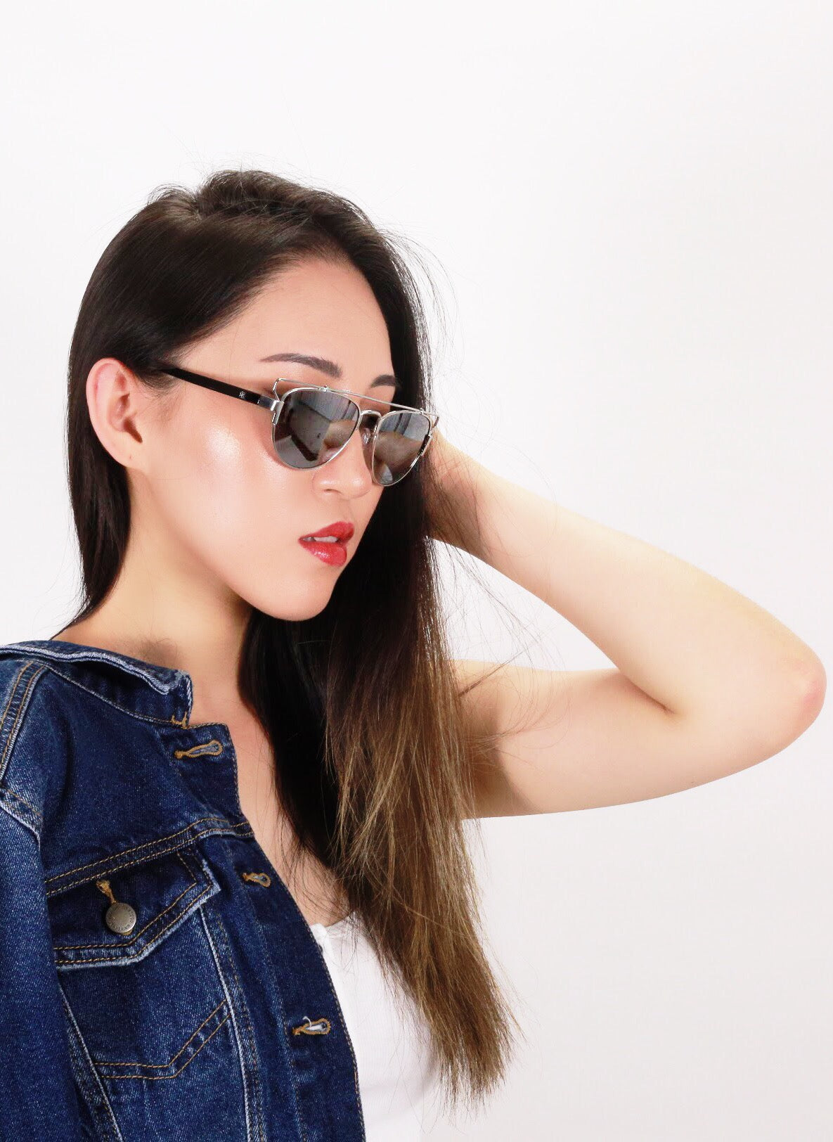 Asian girl with raised arm wears Elenur sunglasses