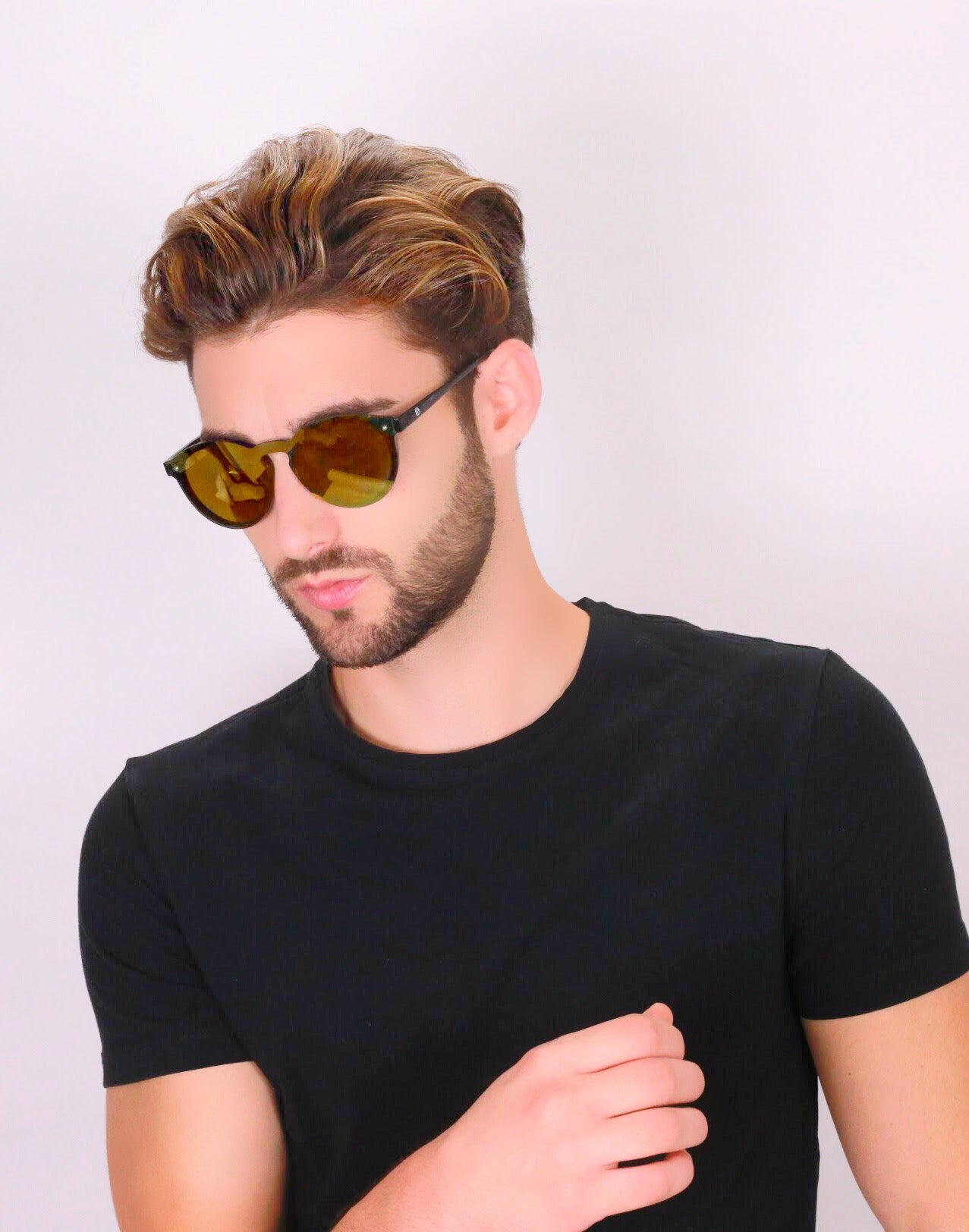 Hungarian man wearing a black shirt and gold Omare sunnies