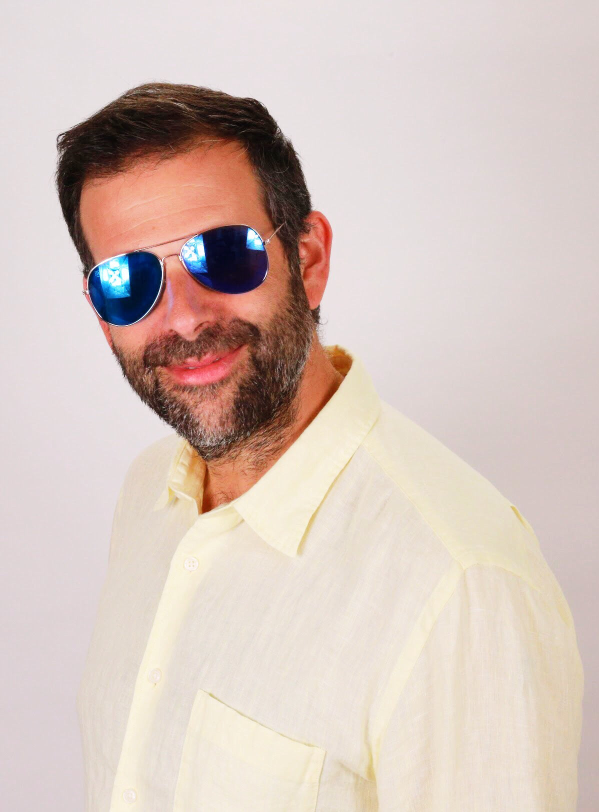 Man with beard wearing blue oak shades