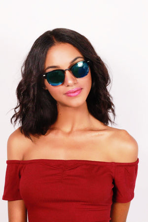 girl with cocked head waering blue Tacoma sunglasses