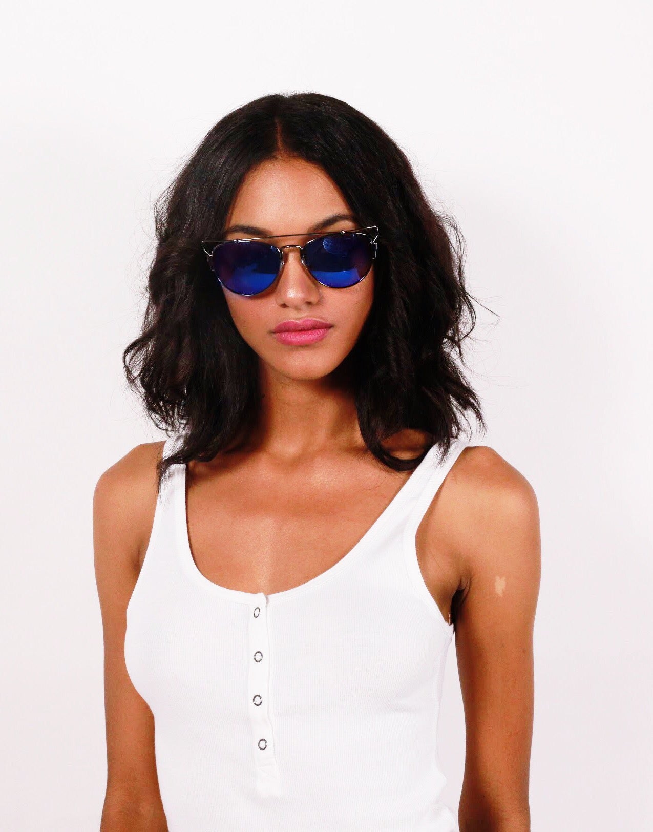 Girl in white shirt wearing blue elenur sunglasses