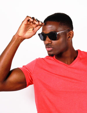 Black man with raised arm wearing Black Mixer sunglasses